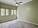 Bedroom featuring gray carpet, a ceiling fan, and windows providing natural light at 10 Stallion Ct, Charleston, SC 29407