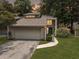 Charming home featuring a driveway leading to a two-car garage and lush surrounding greenery at 10 Stallion Ct, Charleston, SC 29407