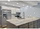 Bright kitchen featuring gray cabinets, stainless steel appliances, and stone countertops at 10 Stallion Ct, Charleston, SC 29407