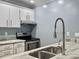 Bright kitchen featuring white cabinets, stainless steel appliances, and stone countertops at 10 Stallion Ct, Charleston, SC 29407