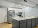 Bright kitchen featuring gray cabinets, stainless steel appliances, and stone countertops at 10 Stallion Ct, Charleston, SC 29407