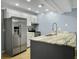 Bright kitchen featuring gray cabinets, stainless steel appliances, and stone countertops at 10 Stallion Ct, Charleston, SC 29407