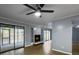 Bright living room with fireplace, ceiling fan, and sliding glass doors to outdoor space at 10 Stallion Ct, Charleston, SC 29407