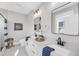 Bathroom with double sinks, white cabinets, and modern fixtures at 101 Hanover St, Charleston, SC 29403