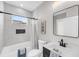 Bright bathroom with stylish fixtures and a modern tiled shower/bath combo at 101 Hanover St, Charleston, SC 29403