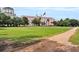 Historical pink building overlooking a lush green lawn with trees and walking path at 101 Hanover St, Charleston, SC 29403