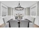 Elegant dining room features stylish chandelier, wainscoting and soft natural light at 101 Hanover St, Charleston, SC 29403