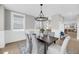 Inviting dining area with modern chandelier, light walls and view to living area at 101 Hanover St, Charleston, SC 29403