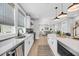 Bright kitchen with white cabinets, large island, and open access to the living room at 101 Hanover St, Charleston, SC 29403