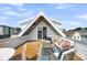 Charming rooftop deck with comfortable seating, a coffee table, and a stylish beachy rug at 101 Hanover St, Charleston, SC 29403
