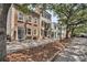 Charming street with historic brick buildings and cobblestone sidewalk lined with mature trees at 101 Hanover St, Charleston, SC 29403