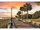 Scenic waterfront path with benches and palm trees, perfect for a leisurely stroll at 101 Hanover St, Charleston, SC 29403