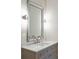 Gray vanity with a marble countertop and a large mirror with decorative trim at 105 Peninsula Dr, Ravenel, SC 29470