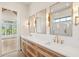 Well lit bathroom featuring double vanity, large mirrors, white counters, and elegant gold fixtures at 105 Peninsula Dr, Ravenel, SC 29470
