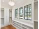 Bright closet featuring custom white cabinets, shelves, hardwood floors, and ample natural light from three windows at 105 Peninsula Dr, Ravenel, SC 29470