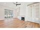 Bright living room featuring a fireplace, built-in shelving, and hardwood floors at 105 Peninsula Dr, Ravenel, SC 29470