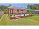 Spacious backyard featuring a wooden deck, potted plants, and a lush grassy area, perfect for outdoor activities and relaxation at 106 Nottingham Ct, Summerville, SC 29485
