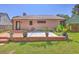 Expansive backyard featuring a patio with a wooden deck, potted plants, and a grassy area, great for entertaining and outdoor living at 106 Nottingham Ct, Summerville, SC 29485