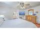 Well-lit primary bedroom featuring a ceiling fan, hardwood floors, and ensuite bathroom at 106 Nottingham Ct, Summerville, SC 29485