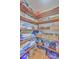 Organized walk-in closet features built-in wooden shelving, storage baskets, and hardwood floors at 106 Nottingham Ct, Summerville, SC 29485