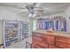 Spacious walk-in closet with organized shelving, hanging rods for clothes, and a ceiling fan, offering ample storage solutions at 106 Nottingham Ct, Summerville, SC 29485
