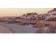 Picturesque row of beach houses at sunset offering stunning views and serene atmosphere at 1064 Blackbear Dr, Edisto Island, SC 29438