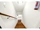 Wooden staircase leading downwards with a white-painted wall and a sturdy handrail for safety at 1064 Blackbear Dr, Edisto Island, SC 29438