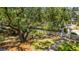 Large grassy backyard area with privacy fence, mature shade trees, and a brick walkway at 11 49Th Ave, Isle of Palms, SC 29451