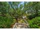 Landscaped backyard with a decorative entrance and lots of mature trees and shrubs at 11 49Th Ave, Isle of Palms, SC 29451