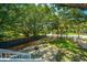Backyard with manicured lawn offers a peaceful retreat with mature trees and fenced perimeter at 11 49Th Ave, Isle of Palms, SC 29451
