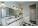 Stylish bathroom with double sinks, black and white floors, and modern walk-in shower at 11 49Th Ave, Isle of Palms, SC 29451
