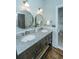 Elegant bathroom features double sink vanity with marble countertop and decorative round mirrors at 11 49Th Ave, Isle of Palms, SC 29451