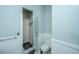 Modern bathroom features sleek glass shower, contrasting black tile, and beadboard accents at 11 49Th Ave, Isle of Palms, SC 29451