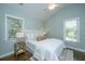 Bright bedroom features light walls, wood floors, and vaulted ceiling with a modern ceiling fan at 11 49Th Ave, Isle of Palms, SC 29451