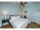Inviting bedroom features wood floors, soft light, and a view to the bathroom at 11 49Th Ave, Isle of Palms, SC 29451