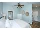 Bright bedroom with wood floors, closet, and a glimpse into the bathroom at 11 49Th Ave, Isle of Palms, SC 29451