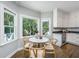 Sunlit breakfast nook with hardwood floors, large windows, and seating for four at 11 49Th Ave, Isle of Palms, SC 29451