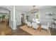 Bright dining room featuring a glass table, stylish chairs, and natural light from the adjacent windows at 11 49Th Ave, Isle of Palms, SC 29451
