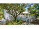 Exterior view of the home with large trees, and an outdoor deck with covered plunge pool at 11 49Th Ave, Isle of Palms, SC 29451