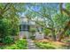 Charming two-story home with a screened porch and landscaped yard offers a welcoming curb appeal at 11 49Th Ave, Isle of Palms, SC 29451