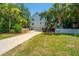 Two-story home with a two car garage, white picket fence, and lush landscaping at 11 49Th Ave, Isle of Palms, SC 29451