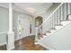 Inviting foyer with hardwood floors, elegant staircase, and decorative chandelier creates a grand entrance at 11 49Th Ave, Isle of Palms, SC 29451