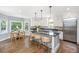 Open kitchen with modern island, stainless appliances, and breakfast nook offers a great cooking and dining space at 11 49Th Ave, Isle of Palms, SC 29451