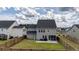 Spacious fenced backyard, patio, and the home's rear facade with multiple windows at 1115 Fitzgerald Ct, Summerville, SC 29485