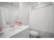 Bright bathroom with a white vanity, fresh flowers, and a shower with a white curtain at 1115 Fitzgerald Ct, Summerville, SC 29485