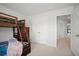 Bright bedroom featuring a wooden bunk bed, neutral carpet, and direct access to the en-suite bathroom at 1115 Fitzgerald Ct, Summerville, SC 29485