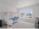 Bright bedroom featuring a bunk bed, neutral carpet, and ample natural light from two windows at 1115 Fitzgerald Ct, Summerville, SC 29485