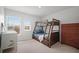 Bright bedroom featuring a wooden bunk bed, neutral carpet, and ample natural light from two windows at 1115 Fitzgerald Ct, Summerville, SC 29485