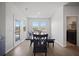 Dining room with wood floors, natural light, and backyard access to the outdoor living spaces at 1115 Fitzgerald Ct, Summerville, SC 29485