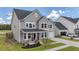 Beautiful two-story home featuring a welcoming front porch, well-manicured lawn, and attached garage at 1115 Fitzgerald Ct, Summerville, SC 29485